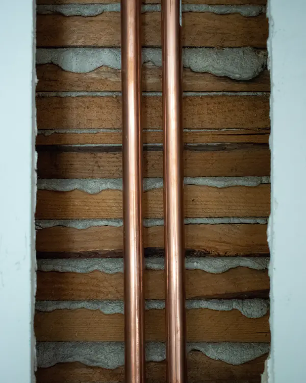 Copper supply pipes inside an open wall